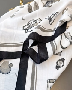 Detail of silk-like scarf featuring elegant hand-drawn fashion motifs and black borders
