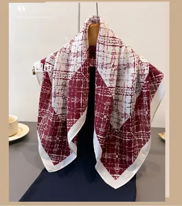 Close-up of geometric plaid pattern on a dark red and beige linen-feel scarf