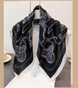Detailed view of lightweight scarf featuring elegant chain and leopard print patterns