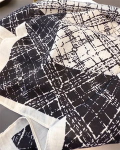 Detail of black and white geometric square pattern on soft textured cotton linen scarf