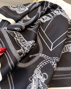 Detailed view of black and white equestrian silk scarf with rope and chain patterns