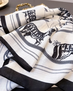 Detail of equestrian horse and chain print scarf showing silk texture and soft folds