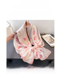 Detail of soft pink silk satin scarf with dark pink tulip floral print on a hanger
