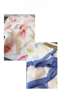 Detailed view of floral silk scarf featuring pink tulips and elegant navy blue hemmed edges