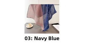Detail of navy blue and pink paisley silk-like scarf draped over a metal rod