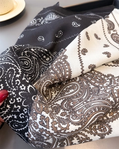 Detail of soft cotton-linen shawl featuring classic paisley pattern and tassel texture