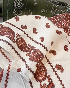 Detail shot of paisley patterns on soft cotton-linen feel square scarves with hemmed edges