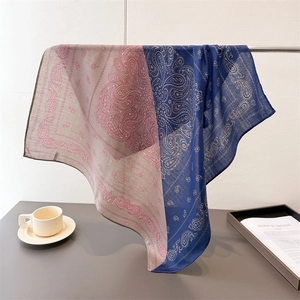 Elegant paisley patterns on large color-block cotton-linen shawl draped over a metal stand