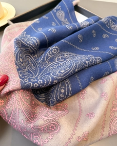 Detail of paisley pattern on twill scarf with navy blue and beige contrast color texture