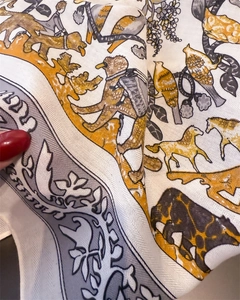 Close-up of herringbone cotton-linen texture silk scarf with animal and leaf patterns