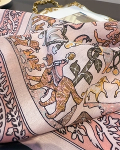 Detailed view of luxury horse print scarf on an elegant golden decorative tray