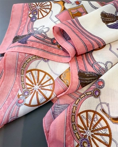 Macro detail of silk-like square scarf featuring vintage horse carriage and tassel patterns