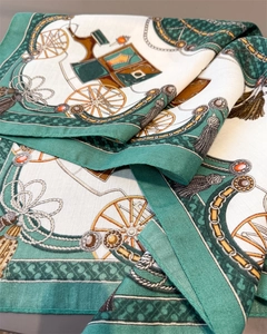 Detailed close-up of retro green silk scarf with elegant horse carriage and chain patterns