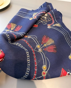 Detail of dark blue satin scarf with vintage carriage print and herringbone texture