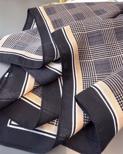 Macro shot of houndstooth and tartan pattern fabric with twill texture and white borders