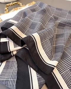 Close-up of houndstooth and geometric pattern scarf with 100% polyester fabric texture