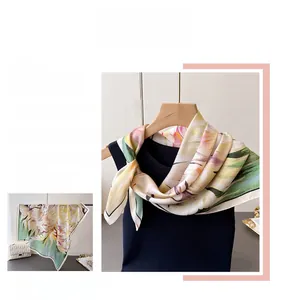 Detail of floral silk scarf with colorful patterns and black and white contrast edges