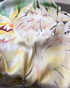 Close-up detail of floral print silk scarf showing luxurious satin texture and drapes