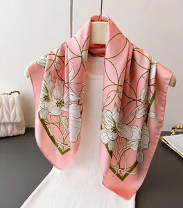 Detailed view of pink floral silk scarf on white mannequin with elegant patterns