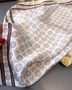 Detailed view of the elegant geometric pattern and silky fabric texture of the scarf