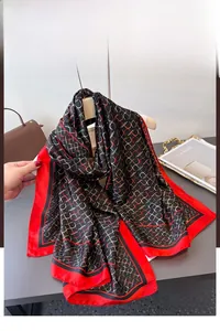 Detail of silk-like scarf featuring geometric chain patterns and bold red border