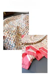 Detail of silk-like satin scarf with colorful geometric patterns and striped edges
