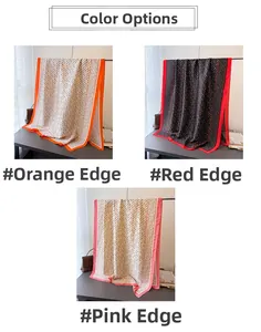 Detailed pattern view of satin silk scarves in orange, red, and pink chain prints