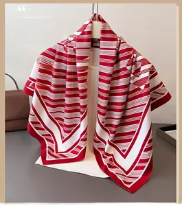Detail showing the red and white striped silk scarf with a glossy satin finish and drape