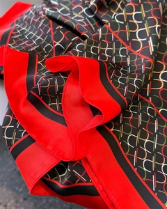 Detail of red and black geometric silk shawl with abstract print and smooth texture