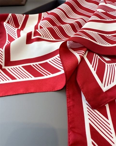 Detailed view of red and white striped faux silk scarf with elegant satin finish texture