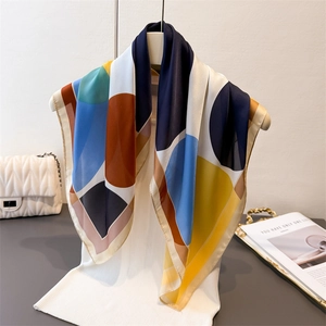 Colorful geometric dot print faux silk square scarf draped on a mannequin