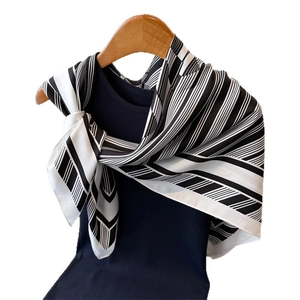 Elegant black and white striped silk square scarf displayed on a wooden hanger
