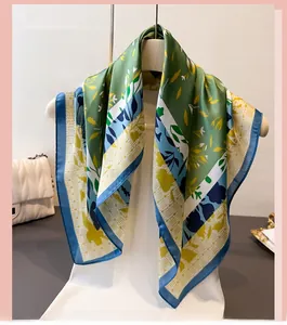 Detail of elegant forest green floral silk-like scarf draped on a female mannequin