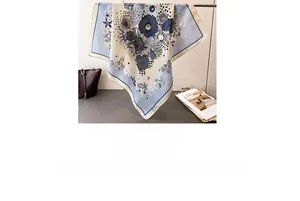 Detail of elegant silk square scarf with blue daisy print and contrast border