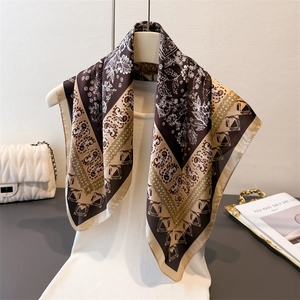 Elegant floral silk square scarf with paisley pattern styled on white knit top