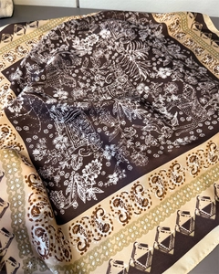 Detail view of paisley pattern and elephant motif on premium floral silk-like scarf