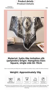 Detailed view of square silk-like scarf with black floral prints on white satin fabric