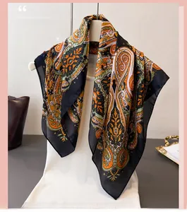 Close-up of exotic paisley printed silk scarf with vibrant orange and green bohemian patterns