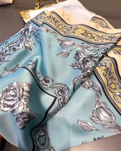 Detailed view of silk square scarf featuring black and white ink flower patterns