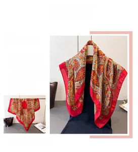 Detailed close-up of exotic red paisley print silk-like scarf with vintage patterns