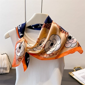 Elegant silk scarf with camellia and chain patterns in navy blue, orange and beige