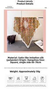 Detail of exotic paisley print satin silk scarf with orange and green floral patterns