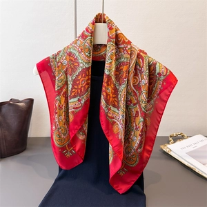 Red paisley faux silk square scarf draped elegantly with a premium satin finish texture