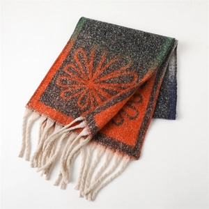 Detail of floral knit scarf with orange sunflower pattern and cream fringe tassels