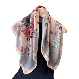 Elegant silk-like daisy flower print square scarf with a smooth satin finish on hangers