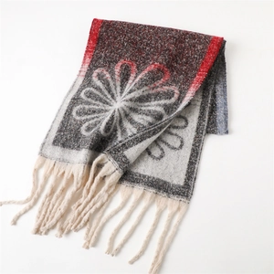 Detail of vintage floral pattern on cashmere-like shawl with elegant white tassels
