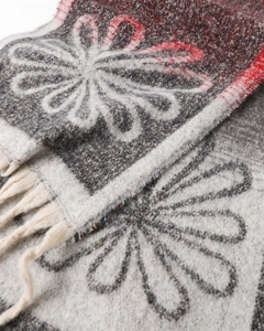 Close-up of vintage floral cashmere-like scarf showing soft fringe and warm knit texture