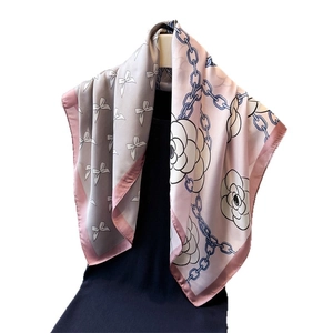 Pink silk-like scarf featuring camellia floral prints and classic chain patterns