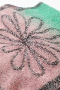 Close-up of floral cashmere feel shawl showing fuzzy texture and pink green color block