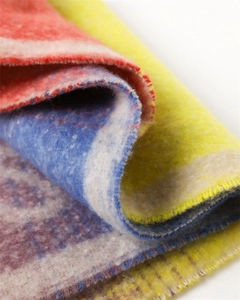 Macro shot of colorful floral pattern cashmere shawl with soft textured tassel fabric